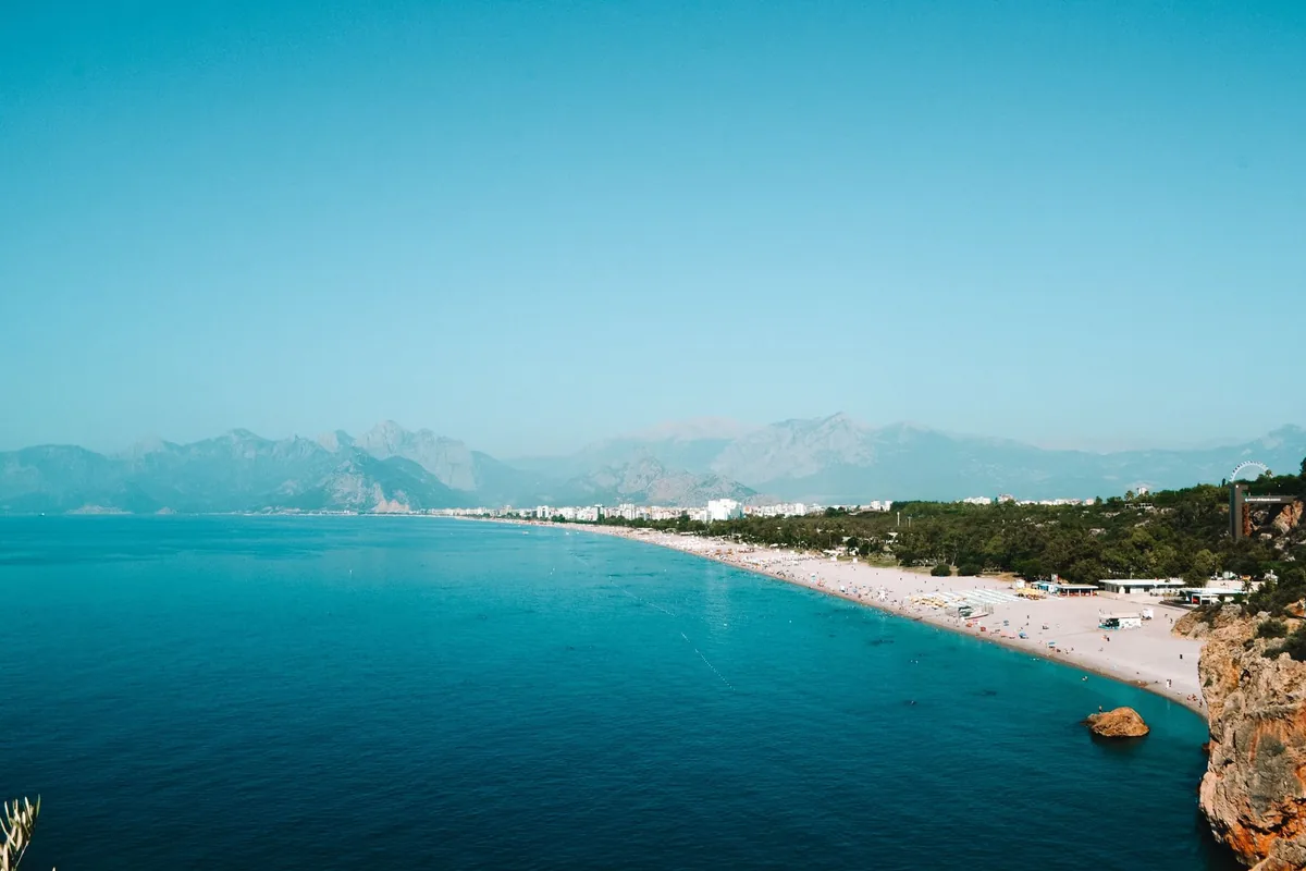 Konyaaltı beach and the long curve of Antalya's bay, with the Taurus mountains behind